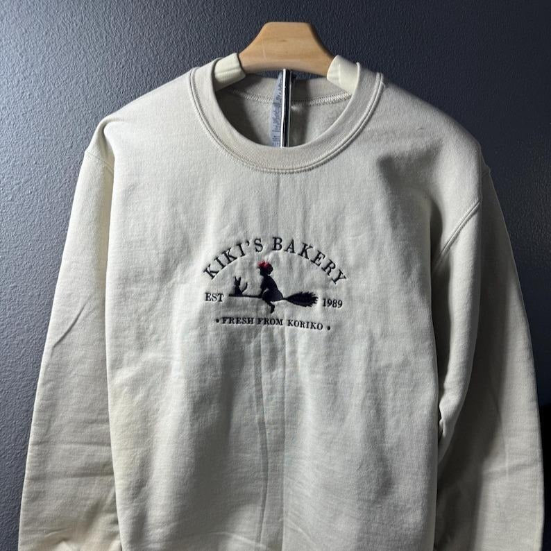 Embroidered KiKi's Bakery Unisex Crewneck Sweatshirt, Jiji Shirt, Kiki's Delivery Service, Studio Ghibli Sweatshirt, Hayao Miyazaki Shirt