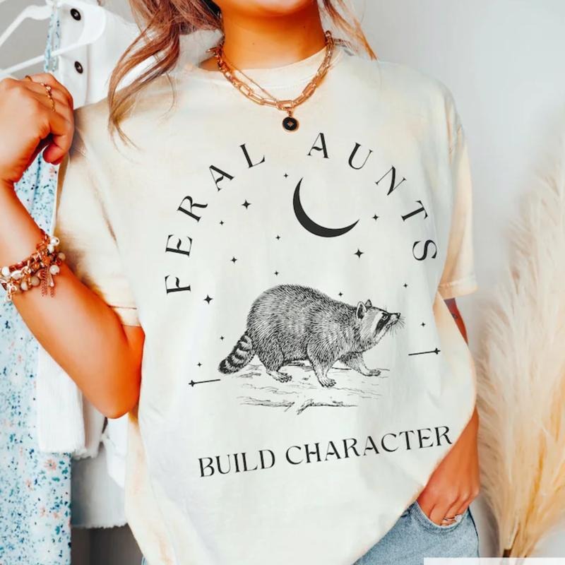 Feral Aunts Build Character T-Shirt, Raccoon Lover Aunt T-Shirt, Vintage Raccoon Art Crescent Moon Tee, Whimsigoth Aunty Tee