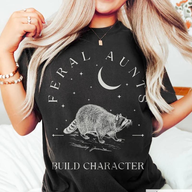 Feral Aunts Build Character T-Shirt, Raccoon Lover Aunt T-Shirt, Vintage Raccoon Art Crescent Moon Tee, Whimsigoth Aunty Tee